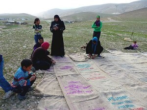 Sewing sacks together to build Mak-hul tent school