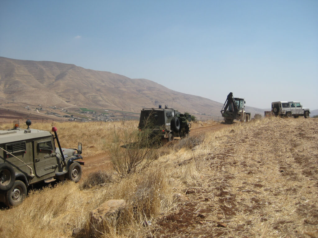 Israeli military and civil administration vechicles leaving after demolition