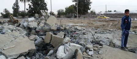 Local resident standing over demolished building