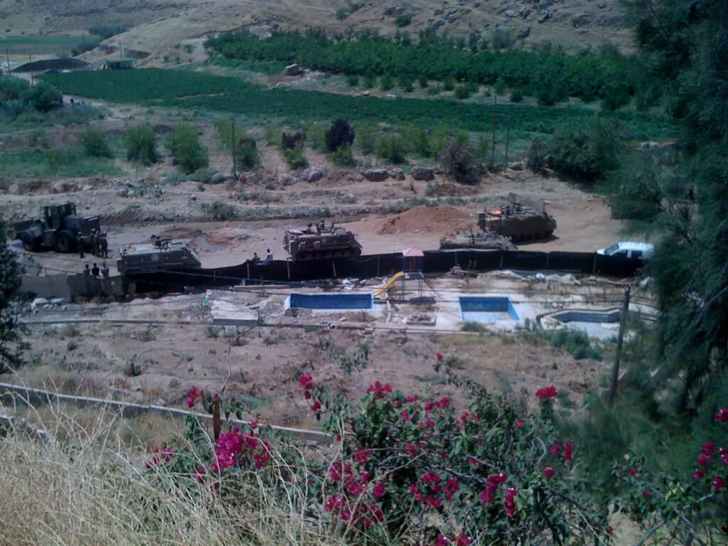 Military training in Area B - Jordan Valley. The close proximity to a children's play area can be seen in the photo. 