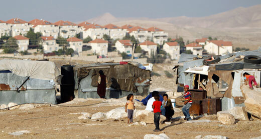 Children of the Jahalin tribe. Israel plans to expel the area’s Bedouin villagers to expand the settlement of Ma’ale Adumim (background). Photo: ‘Ammar ‘Awad, Reuters, 16 June 2012