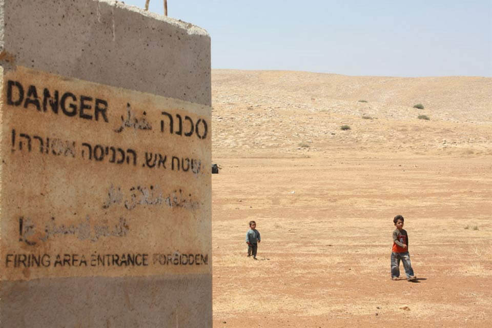 Bedouin children wander away from their home in al-Hadidiya village in the West Bank, which is now within a closed military zone claimed by the Israeli army. Photo: IRIN/Phoebe Greenwood