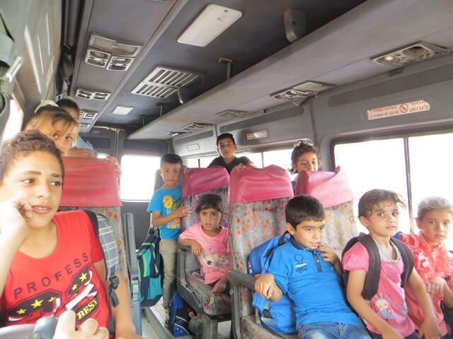 Children travelling to school in the JVS school bus